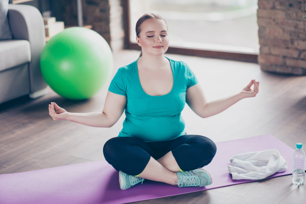 fighting pcos belly fat: woman meditating
